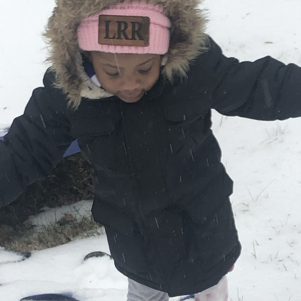 toddler girl playing in the snow